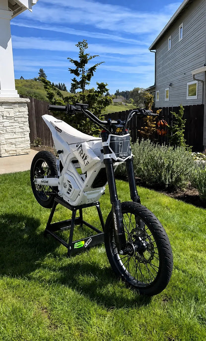 Chrome 17 inch front and 14 inch rear supermoto wheel set on a white Yozma